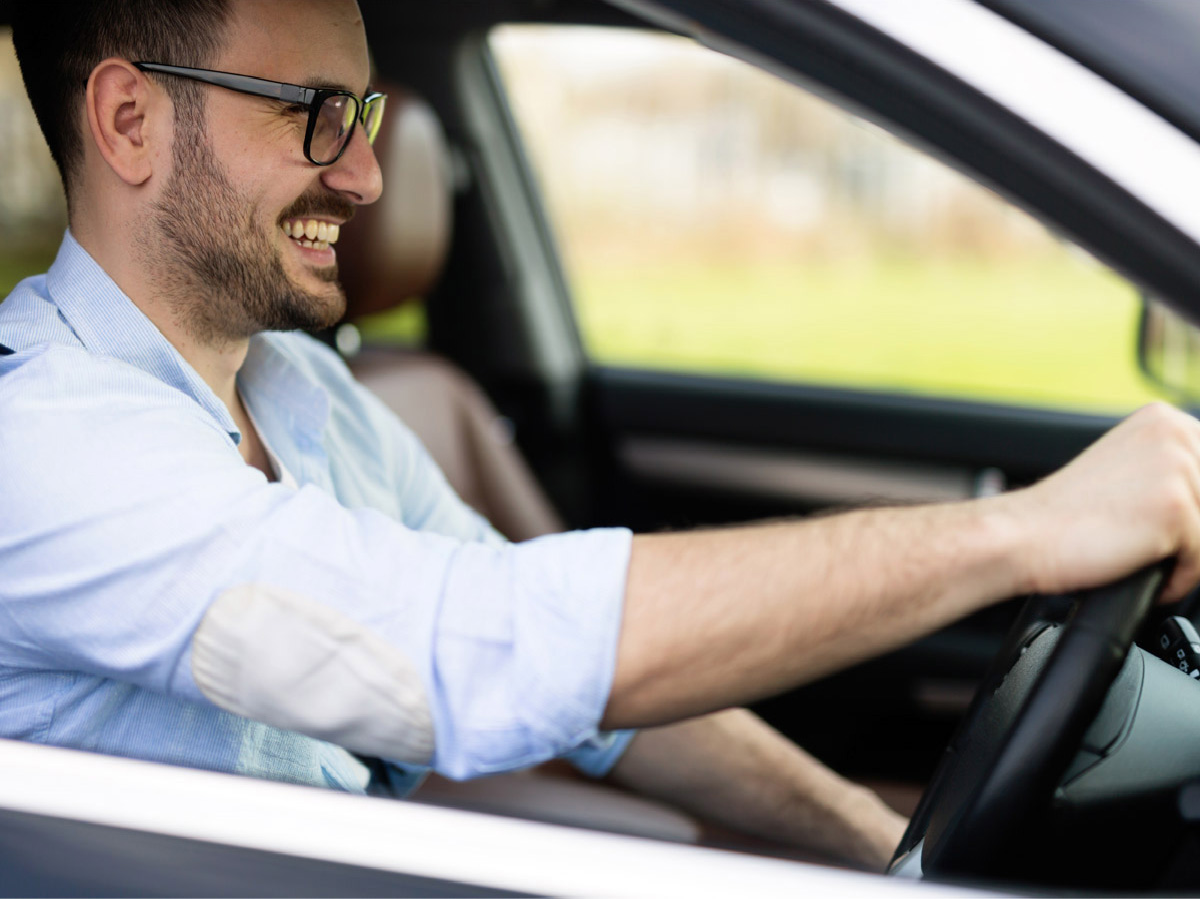 confident male driving car